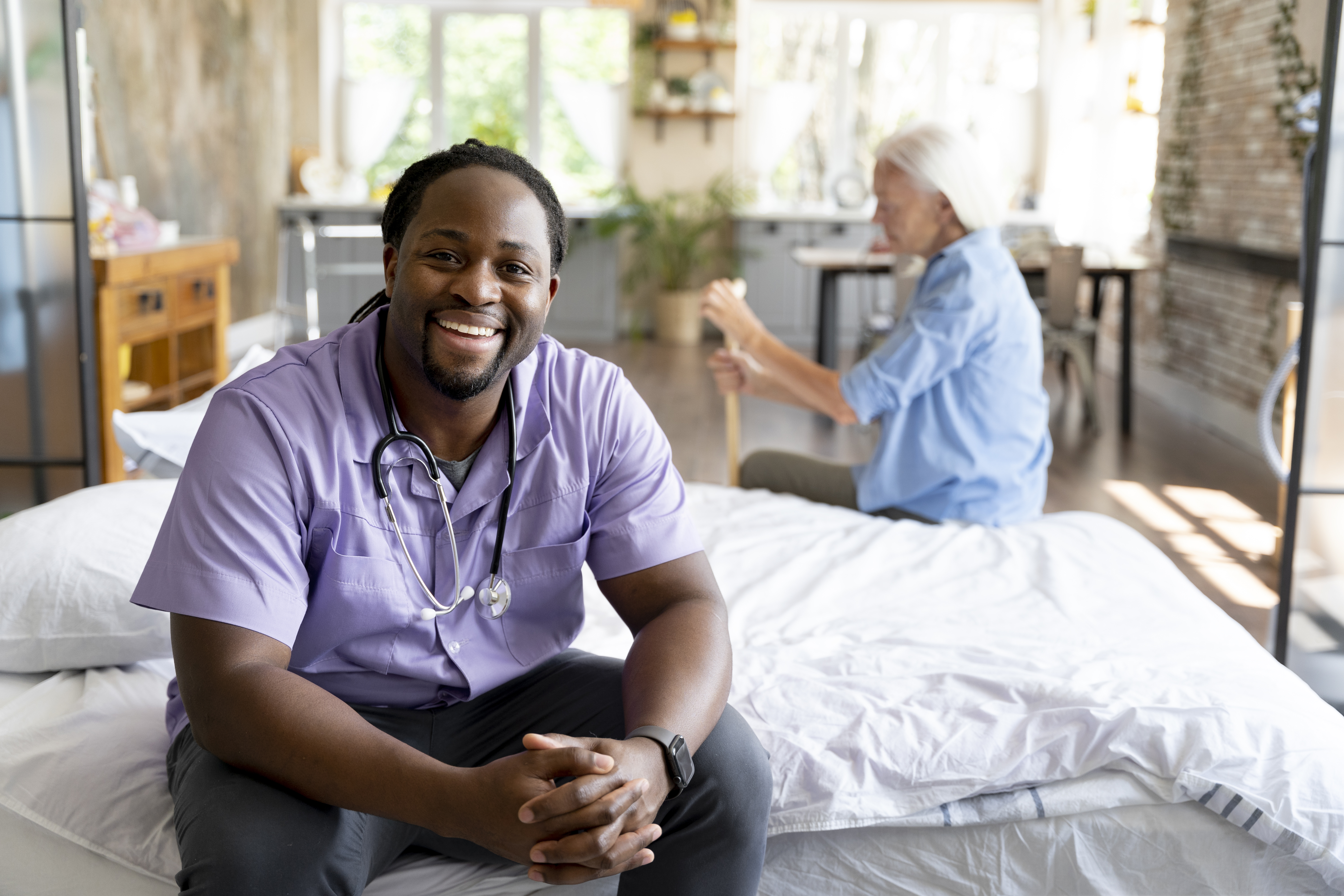 Family caregiver assisting healthcare professional with patient care